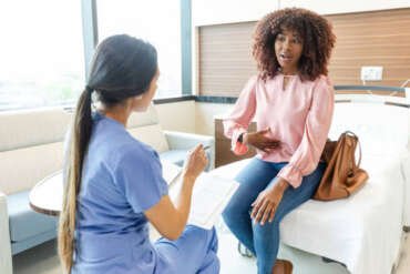 A patient seated in a waiting area, appearing calm and empowered, emphasizing the right to non-judgmental healthcare.