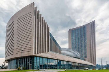 A dramatic, wide-angle shot of the African Union HQ in Addis Ababa.