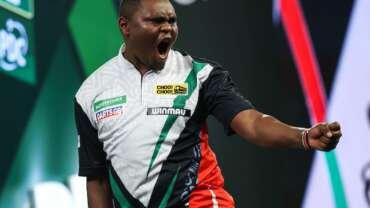 David Munyua celebrates his historic World Darts Championship victory, after becoming the first Kenyan to win a match at the PDC tournament.